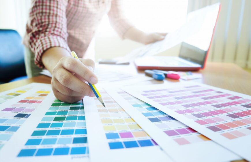 Graphic designer at work. Color swatch samples.